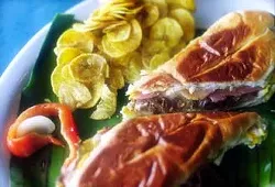 A Cuban sandwich at La Marginal, flanked by plantain chips.