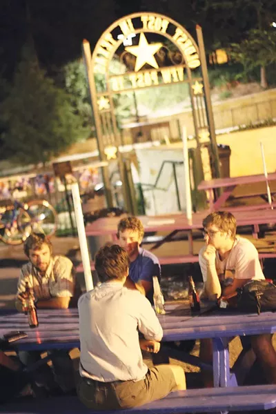 A group of drinkers contemplate last call under another of VFW's gateway arches. - CHUCK KERR