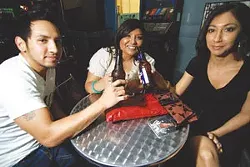 Adrian Torres, Marzella Fela, and Yvonne Valdez enjoy a drink at the Pedicab Bar & Grille.