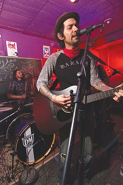 Blackbird Sing’s Robert Salinas serenading the redhead at the door. - STEVEN GILMORE