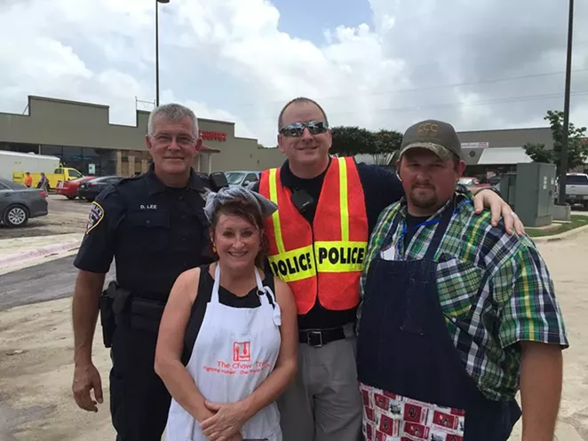 Cheever with volunteer helpers on Tuesday, May 26. The truck was parked next to a heavily hit strip center and neighborhood in San Marcos. - THE CHOW TRAIN/FACEBOOK