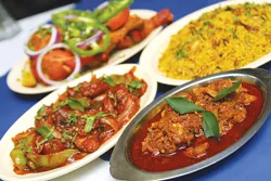 Clockwise from left: Chicken 65, T.D. Chicken, Chicken Biryani, and Fish Masala from Taste of Malabar.
