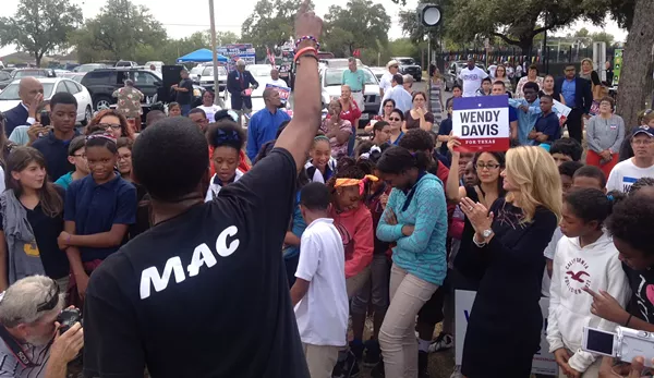 Wendy Davis dances to Real Musiq's performance at the Claude Black Center in east San Antonio - ALEXA GARCIA-DITTA
