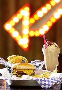 The double Lucky with cheese served with fresh-cut fries, an order of homemade onion rings, and a chocolate shake.