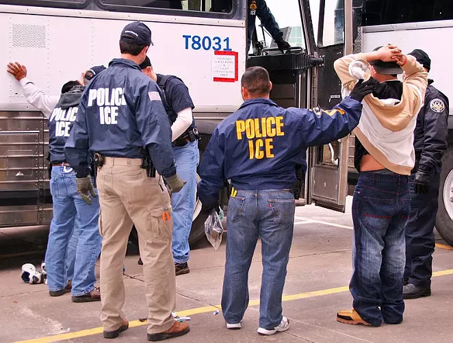 ICE agents arrest a suspect during a raid. - WIKIPEDIA COMMONS