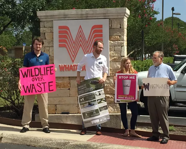Luke Metzger (second from left) and other members of Environment Texas hold signs in front of Whataburger's S.A. headquarters. - SANFORD NOWLIN