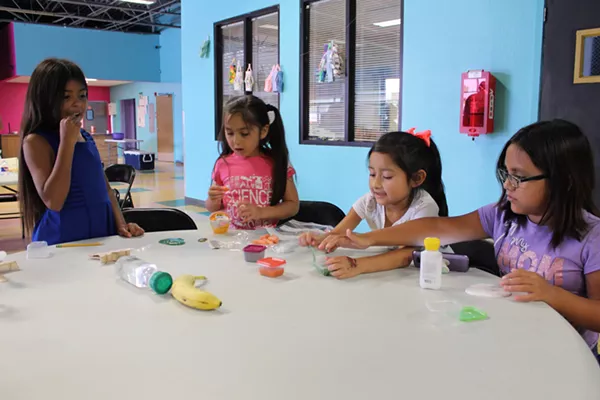 SA Youth at Poplar distributes San Antonio Food Bank meals to 50 to 60 children every day. - MEGAN RODRIGUEZ