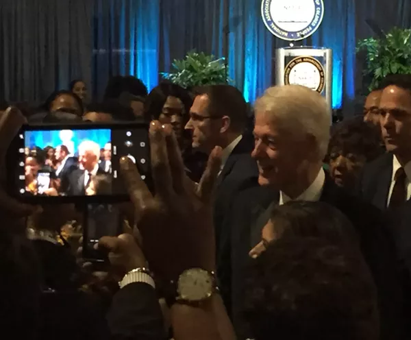 President Bill Clinton makes his entrance at the NAACP's gala. - SANFORD NOWLIN