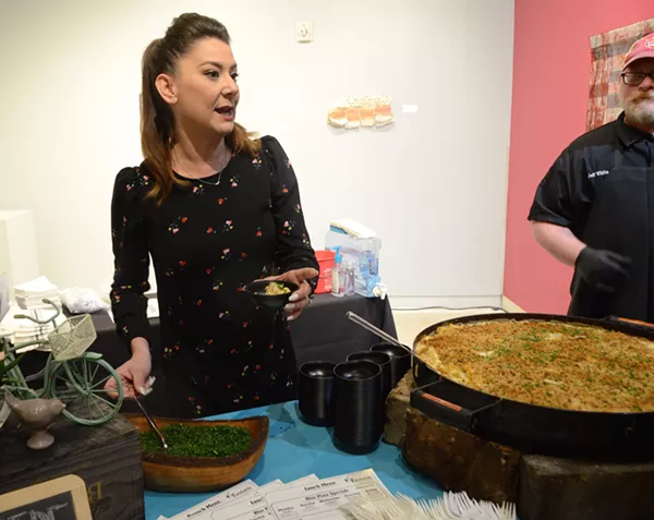 Jenn White of Eastside Kitchenette serves up bacon mac and cheese at the Women Shaking It Up event. - LEA THOMPSON