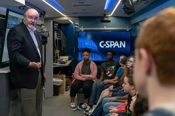 A Harris County precinct commissioner visits with students on the C-Span bus. - TWITTER / CSPANBUS