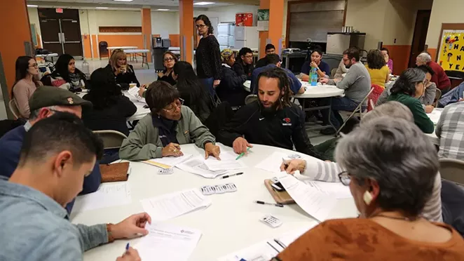 Vallerie Hartfield (left) and Stephen Lucke discuss a question presented to attendees of a city-hosted displacement policy meeting Jan. 16 at the Ella Austin Community Center. - BEN OLIVO / HERON