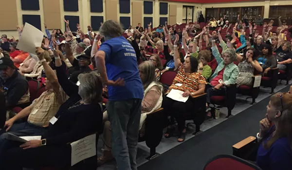 A BCDP official counts votes on whether to ban another precinct chair from meetings. - SANFORD NOWLIN