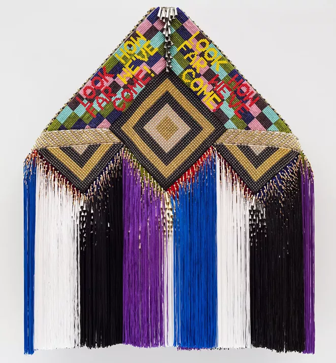 Jeffrey Gibson. LOOK HOW FAR WE'VE COME!, 2016. Glass beads, tin jingles, copper cones, steel, nickel, and brass studs, nylon fringe, artificial sinew, and acrylic paint on wool blanket, mounted on canvas, 69 x 73 x 7 in. (175.3 x 185.4 x 17.8 cm). Courtesy of the artist; Roberts Projects, Los Angeles; Sikkema Jenkins & Co., New York; and Kavi Gupta, Chicago. © Jeffrey Gibson. - PETE MAUNEY