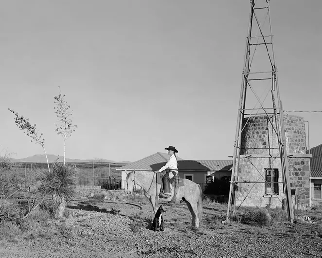 This photo is titled "Evan Hall mounted on favorite horse 8-Ball." This is one of a series of photographs depicting modern cowboys at the SaddleUp exhibit. - JOE VITONE PHOTOGRAPHY