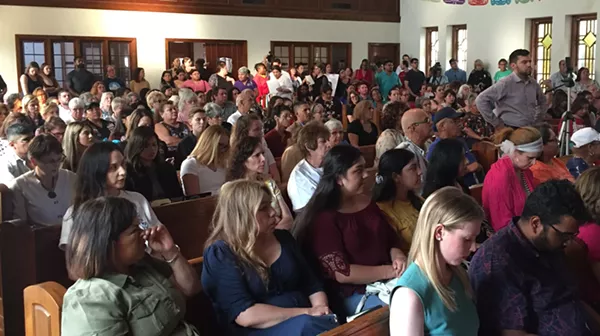 People at a San Antonio town hall on domestic violence listen to a survivor share her story. - SANFORD NOWLIN