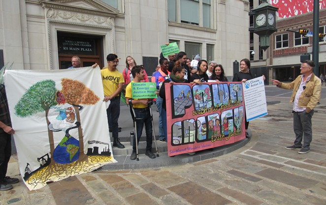 Activists rally outside council chambers following the vote on the limate Action & Adaption Plan. - RHYMA CASTILLO