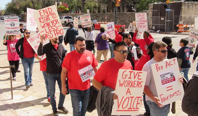 Communications Workers of America members stage a protest in front of the downtown San Antonio office of U.S. Rep. Henry Cuellar. - SANFORD NOWLIN