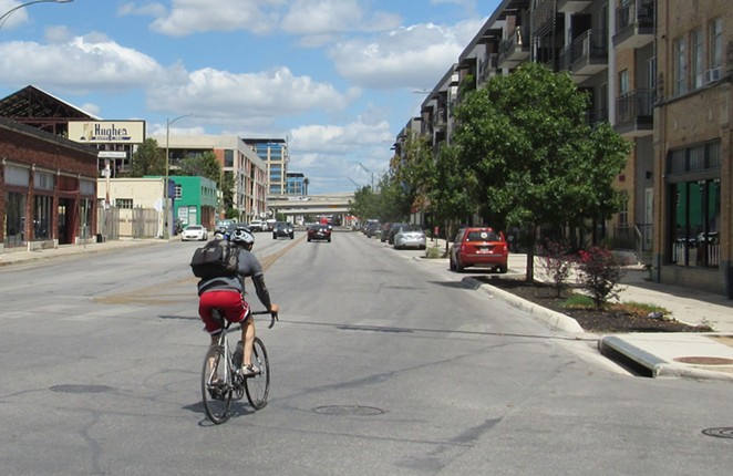 A cyclist pedals north from downtown on Broadway. - SANFORD NOWLIN