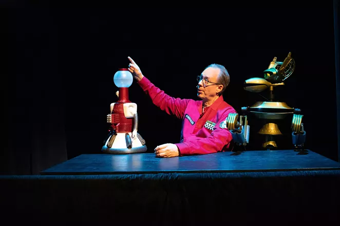 Host Joel Hodgson points out a movie's awfulness to his robot pals. - BRANDI MORRIS