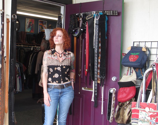 Tabitha Garcia-Rogers looks out the door of her vintage clothing shop, Thrash Weave. Even before city council voted to close most businesses for 30 days, she'd seen virtually no customer traffic. - SANFORD NOWLIN