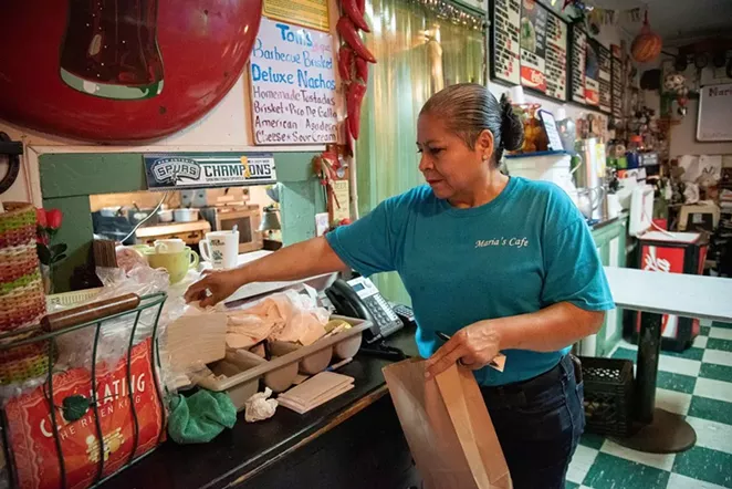 Maria Beza, owner of Maria’s Cafe on Nogalitos Street, completes an order on Thursday. - V. FINSTER | HERON CONTRIBUTOR