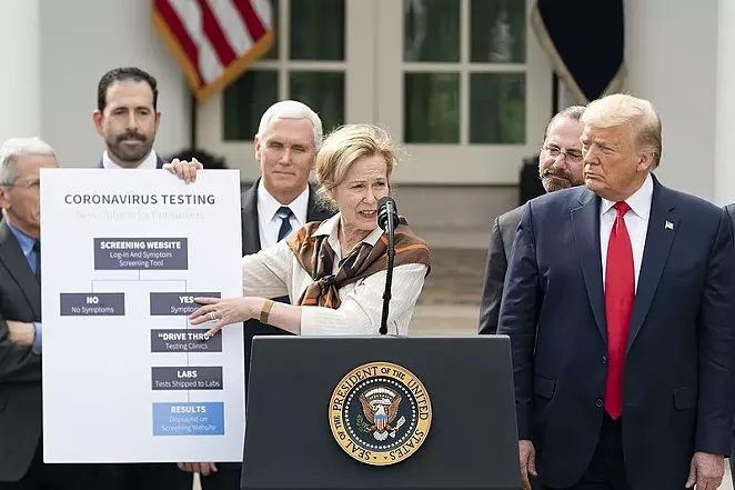 President Donald Trump actually listens to an expert during a coronavirus news conference. - WHITE HOUSE
