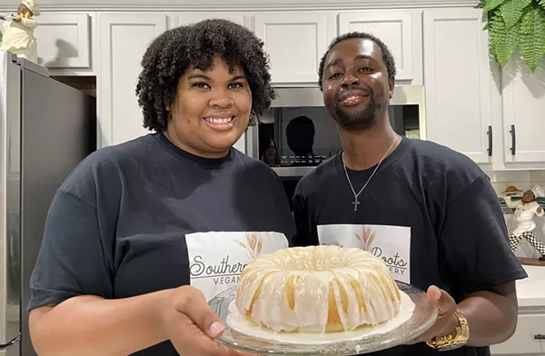 Marcus and Cara Pitts of Southern Roots Vegan Bakery show off one of their cakes. - COURTESY SOUTHERN ROOTS VEGAN BAKERY
