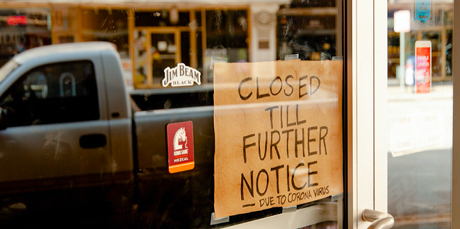 A homemade closure sign hangs in the window of a downtown San Antonio business. - AIMEE WYATT