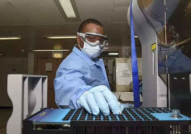 A laboratory technician tests plasma samples. - COURTESY PHOTO / GINA ORTIZ JONES