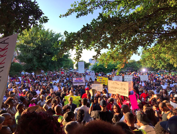 Hundreds demonstrated outside an elementary school in McKinney to protest. - VIA TWITTER USER @DERAY