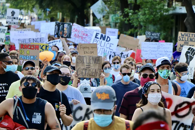 Protesters move through the streets of Downtown San Antonio this spring during a protest against police brutality. - JAMES DOBBINS