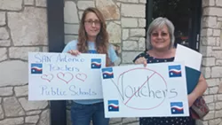 Cassandra Wilson (left) and Kim Martinic (right) were asked to leave the rally because of their signs. They were later readmitted, sans-signs. - VIA MICHAEL MARKS