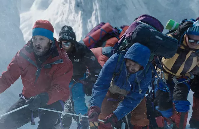 A group of climbers struggle in blizzard conditions. - COURTESY