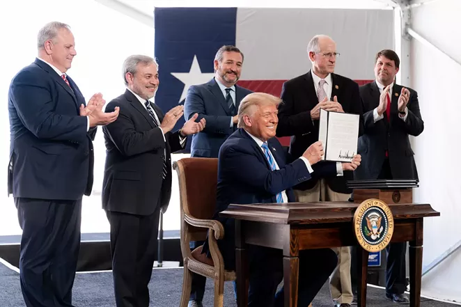Donald Trump shows off his signature on federal permits during an appearance in Midland this summer. - COURTESY PHOTO / THE WHITE HOUSE