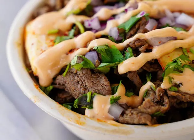 Coreanos' B.A.P features seasoned rice, marinated beef bulgogi, spicy marinated chicken with onions, cilantro, cheese and El Scorcho sauce. - COURTESY COREANOS