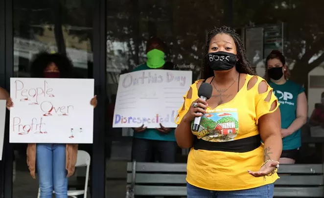 Alazán Courts resident Jacquline Caldwell speaks at a protest in front of SAHA headquarters on Saturday. - BEN OLIVO / SA HERON
