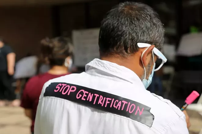 A protestor attends a rally Saturday at SAHA headquarters. - BEN OLIVO / SA HERON