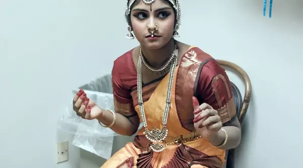 Bharatanatyam dance student Gayathri Evani gets ready backstage for her performance captured in the documentary short film Of Gods and Bells. - COURTESY