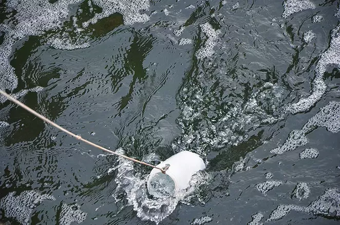 SAWS’ Gregg Eckhardt scoops water that just left the recycling plant.