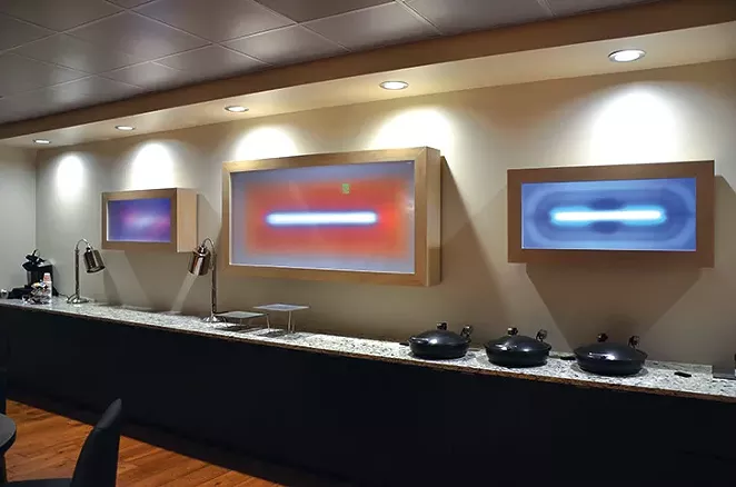Light installations by Cathy Cunningham-Little glow in a Spurs suite.
