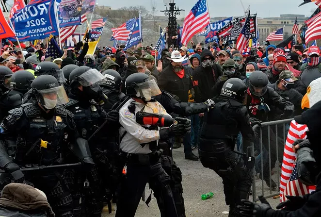 A pro-Trump mob overruns barricades at the U.S. Capitol during last Wednesday's insurrection. - SHUTTERSTOCK