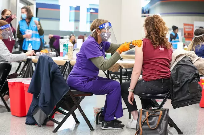 Workers at the city's Alamodome vaccination site administer COVID-19 shots. - CITY OF SAN ANTONIO