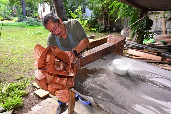Gregorio “Goyo” Rebollar at work on a torchiere