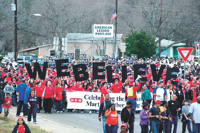 H-E-B employees carry a sign reading "WE BELIEVE" at San Antonio's Martin Luther King Day march. - SARAH BROOKE LYONS