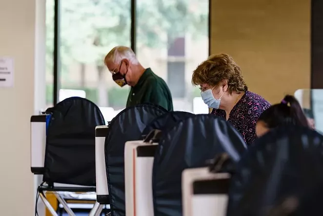Voters cast their ballots at the Performing Arts Center at Texas State University in San Marcos. - TEXAS TRIBUNE / JORDAN VONDERHAAR