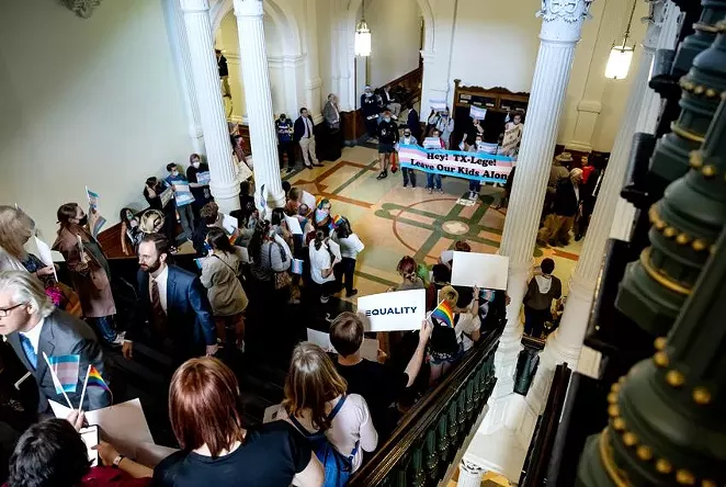 Transgender rights activists gather outside the entrance to the Texas in the state Capitol on Sunday. Senate bills limiting transgender children's participation in sports and health care options had a 10 p.m. deadline to be scheduled for House debate if they were to advance in the legislative process. - TEXAS TRIBUNE / JORDAN VONDERHAAR