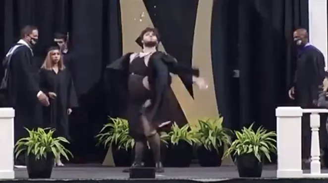 A Clark High School graduate reveals a naughty garment hidden under the school's graduation robe on June 8. - SCREEN CAPTURE / FACEBOOK / ERIAL SOLIZ HURTADO