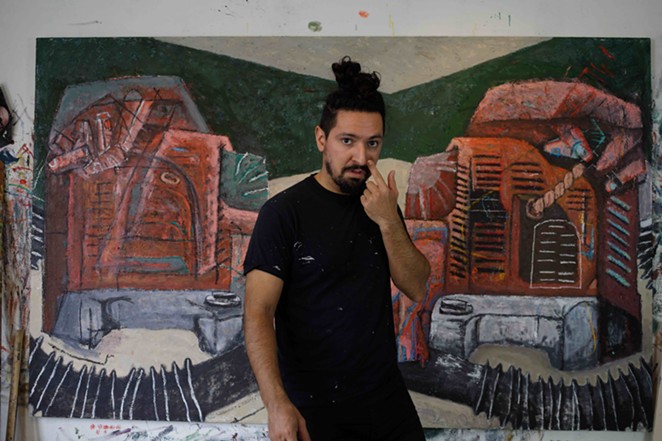 John Guzman with his painting The sound of making a living. - KIKÉ SAN