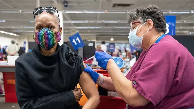 A San Antonio resident gets her jab at a mass vaccination site earlier this year. - UNIVERSITY HEALTH