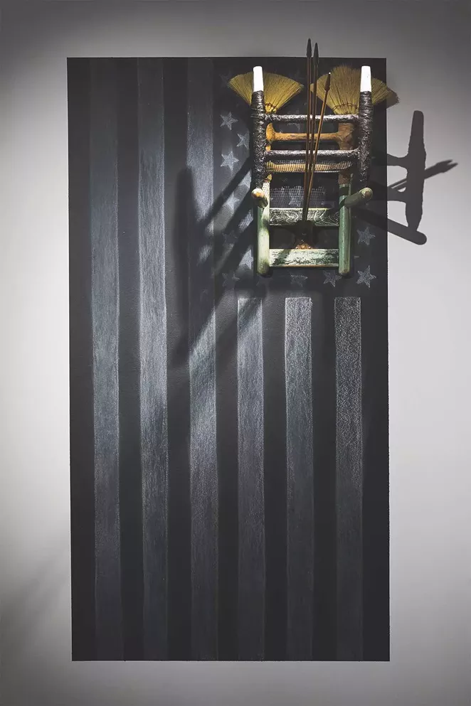 Ariel René Jackson, The next life of property, 2019, chair erected onto chalk rendering of US flag; Tampico broom corn via Mexico, Texas sourced soil, chalkboard paint, concrete, 60 x 36 x 48 in. - IMAGE COURTESY THE ARTIST. © ARIEL RENÉ JACKSON 2019.